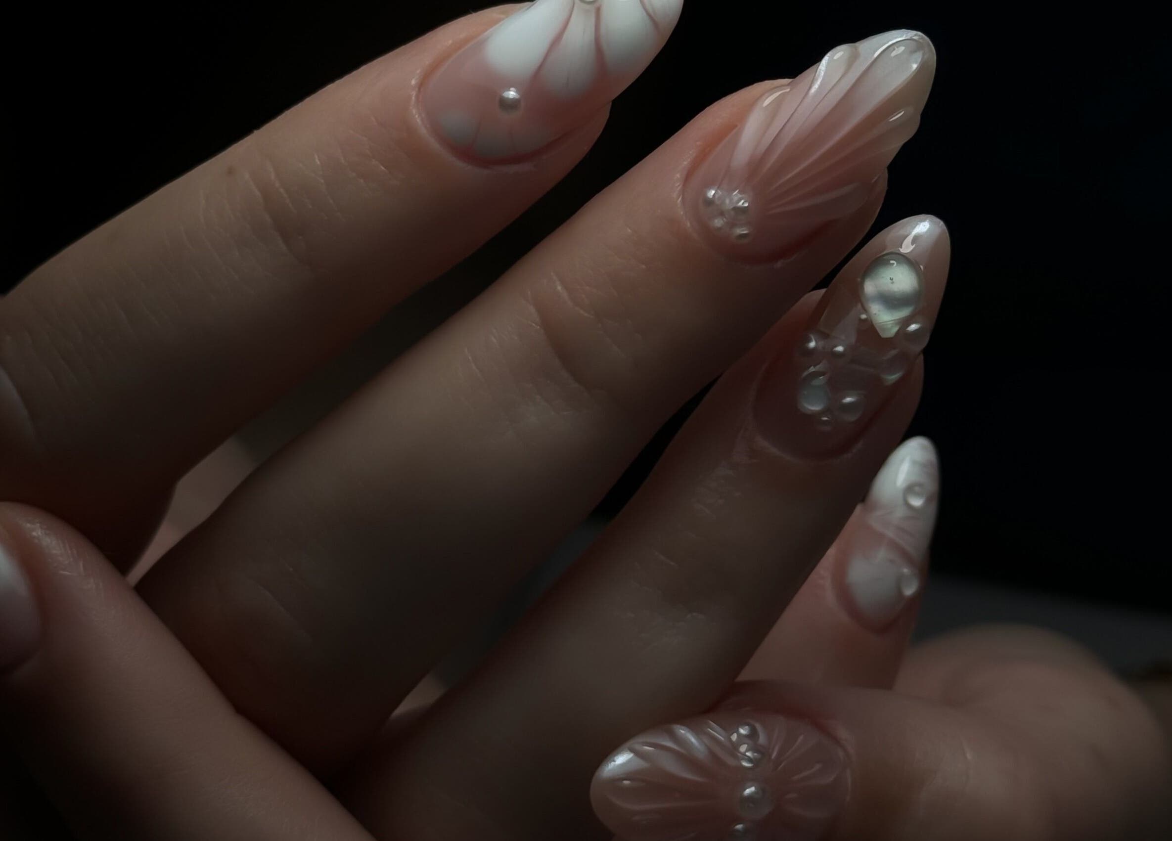 Close-up of intricate nail art at Cupid Nail Studio, Varsity Lakes, Queensland, AU, featuring pearlescent designs.