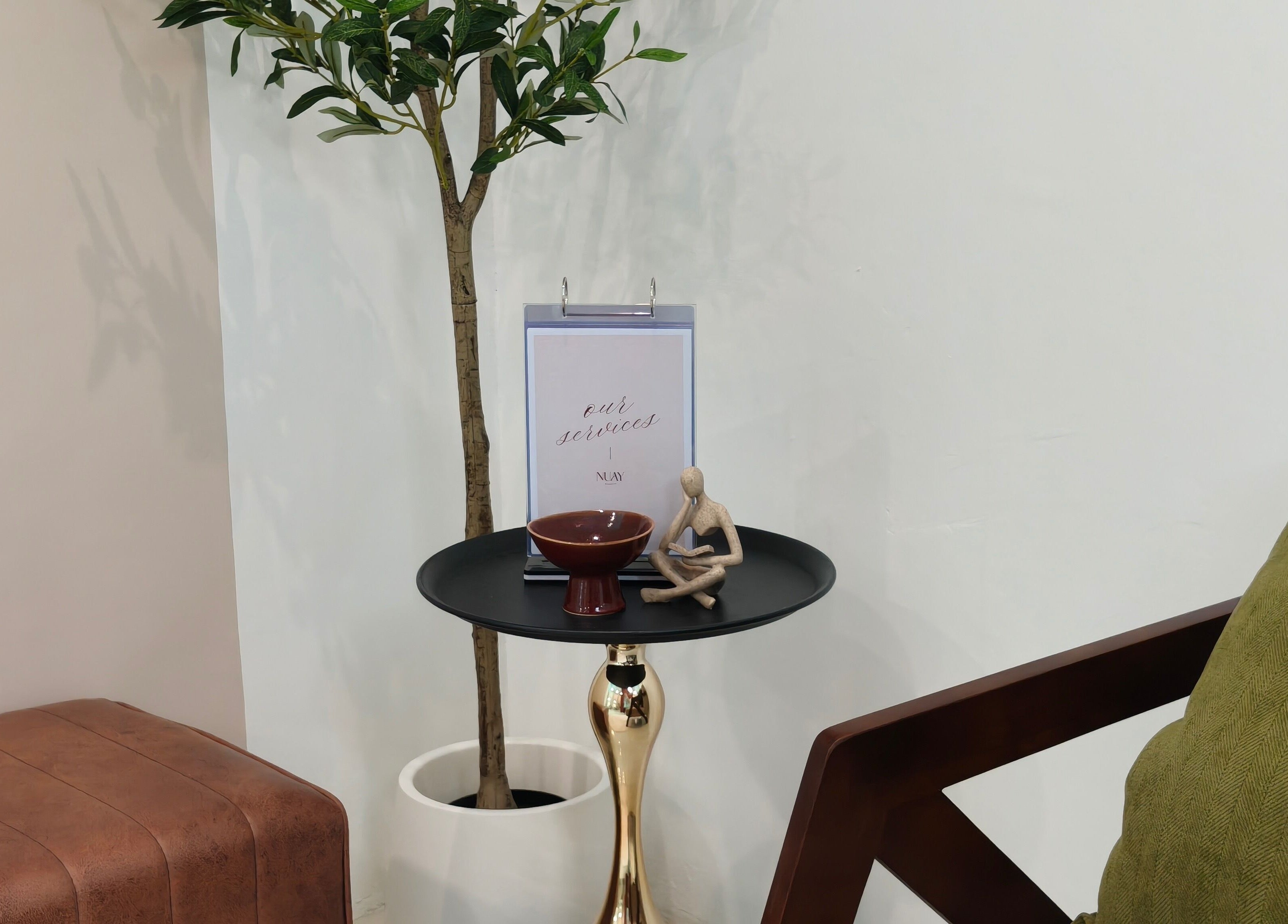 Peaceful corner at Nuay Beauty, Shah Alam, Selangor, MY, featuring a table with decor and a touch of greenery.