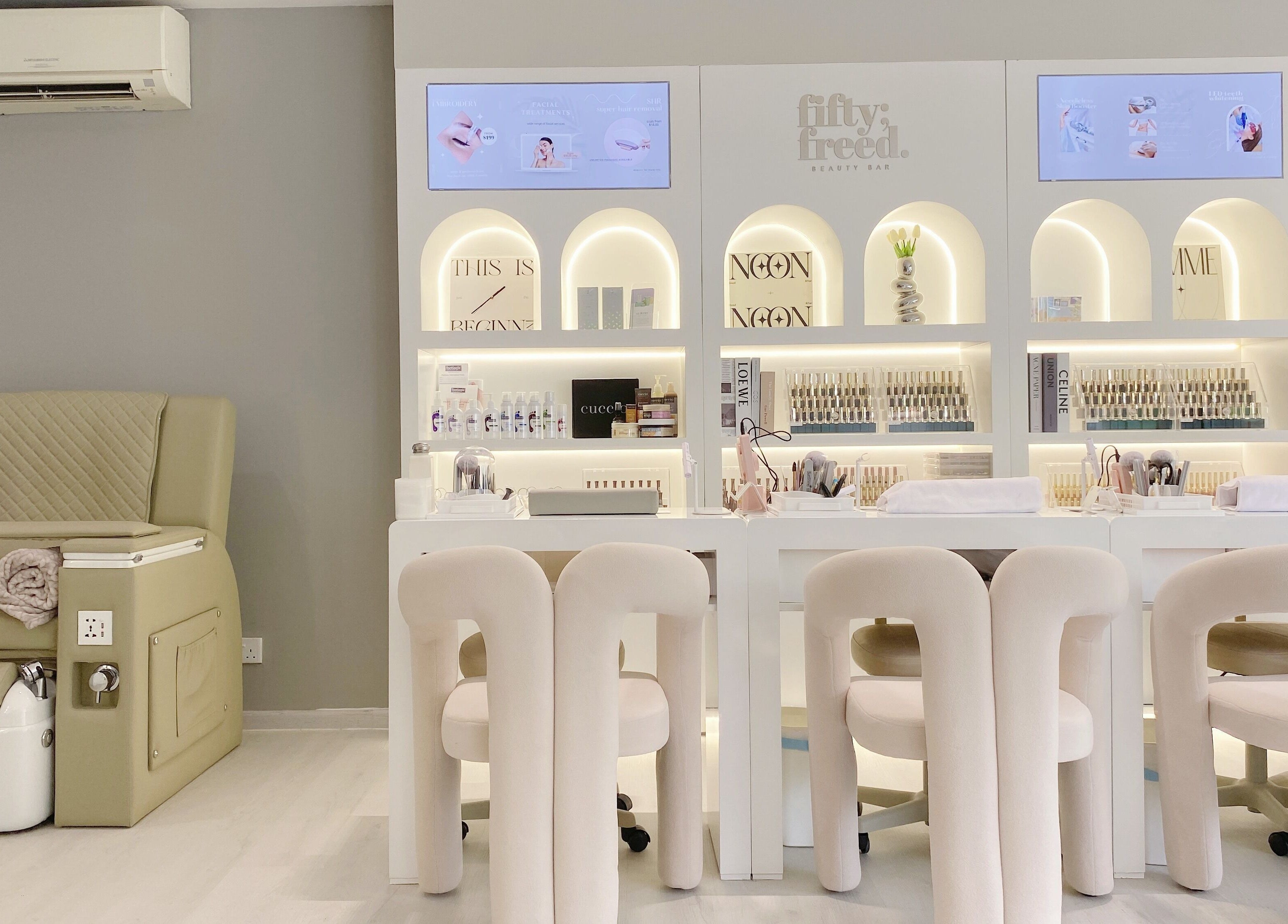 Modern beauty lounge at @fiftyfreed.sg - Eng Kong Terrace, Singapore, featuring stylish seating and nail products.