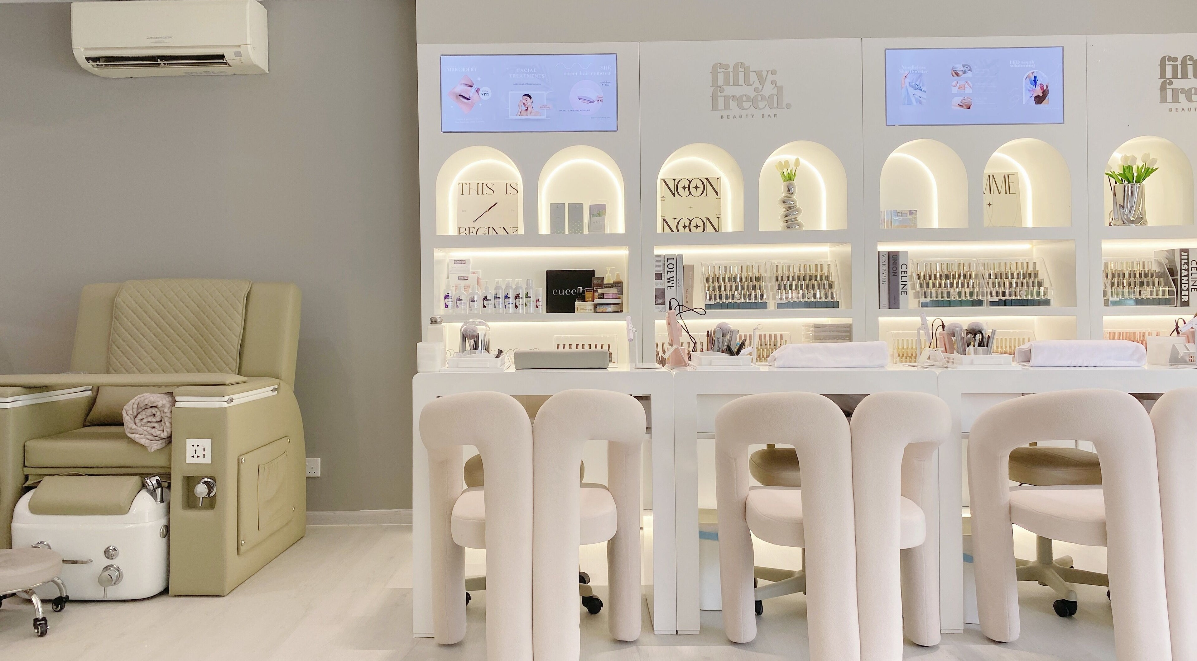 Modern beauty lounge at @fiftyfreed.sg - Eng Kong Terrace, Singapore, featuring stylish seating and nail products.