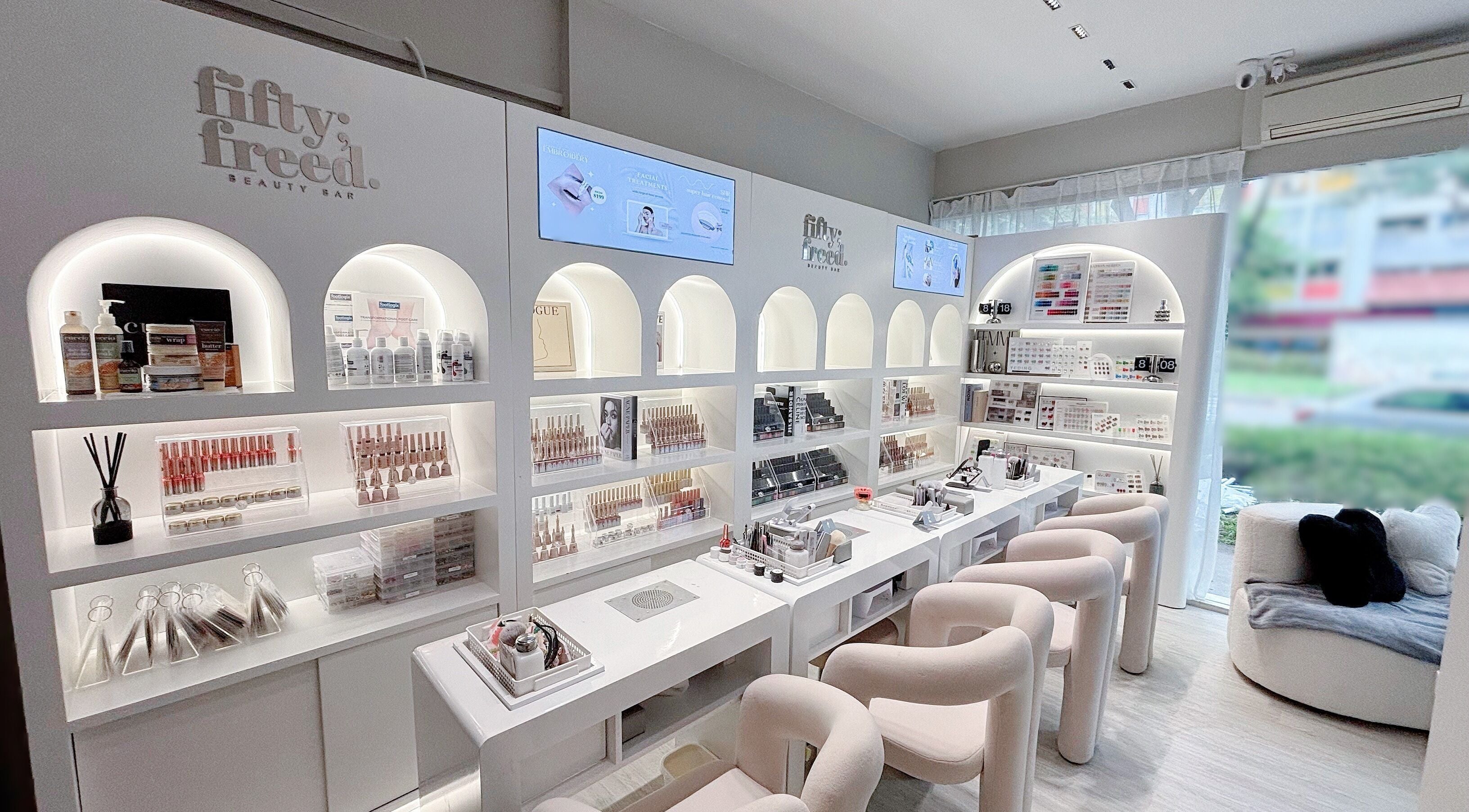 Elegant interior of @fiftyfreed.sg - Aljunied, Singapore, SG, showcasing modern beauty products and seating area.