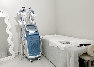 Modern treatment room at @fiftyfreed.sg - Kovan, Singapore, SG, featuring a mirror, equipment, and a massage table.