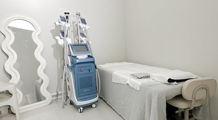 Modern treatment room at @fiftyfreed.sg - Kovan, Singapore, SG, featuring a mirror, equipment, and a massage table.