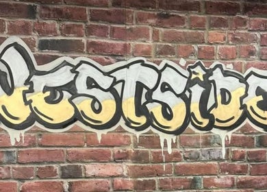 Colorful Westside mural on brick wall at Westside Beauty & Barbershop in Dunkirk, Indiana, US.