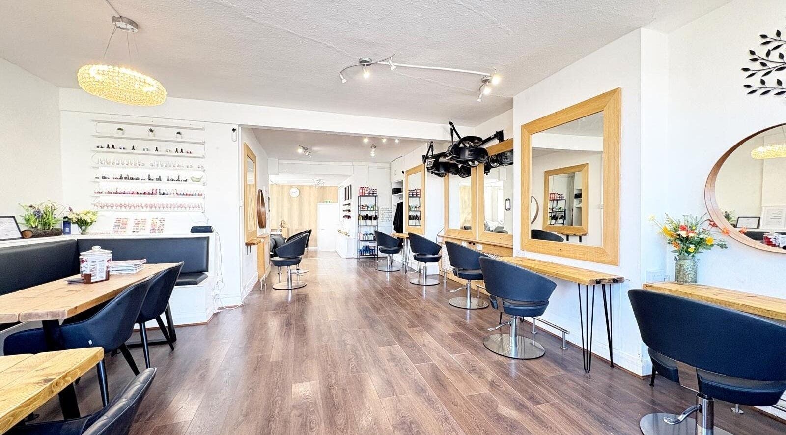Elegant salon interior at Hairline - Southfields, Southfields, United Kingdom, GB with mirrors and seating.