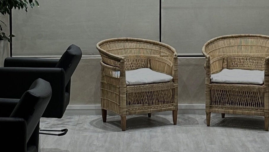 Stylish rattan chairs in the welcoming area of BLONDKOP, Cape Town, Western Cape, ZA.