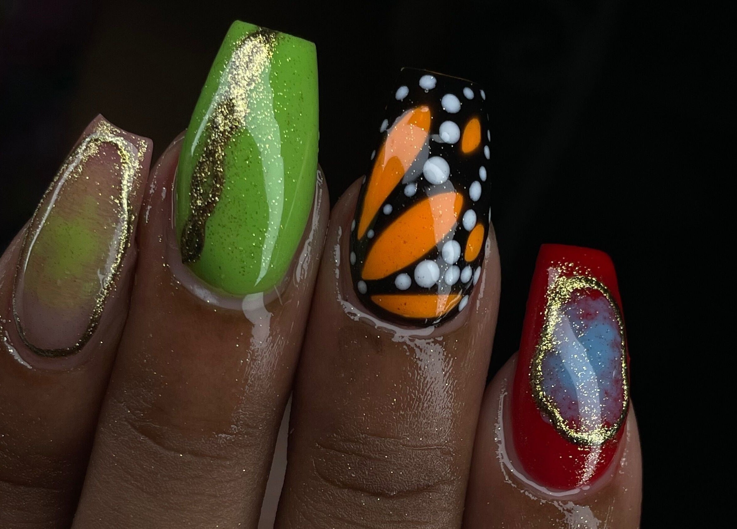Vibrant nail art at Tiff’s Creations, Bridgetown, Saint Michael, BB. Features green, orange, and red designs.