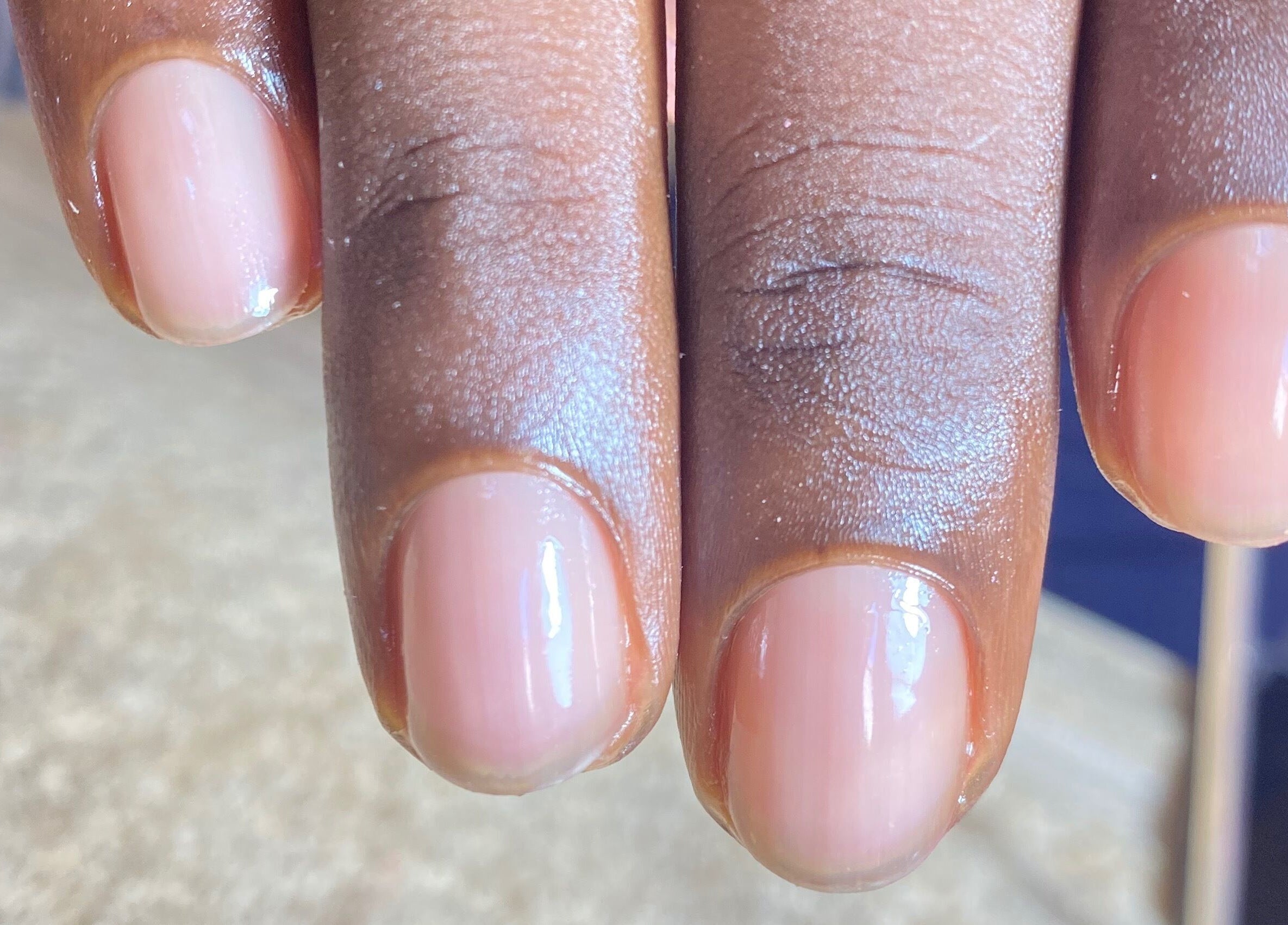 Close-up of a manicured hand at Tiff’s Creations, Bridgetown, Saint Michael, BB showcasing natural nail polish.