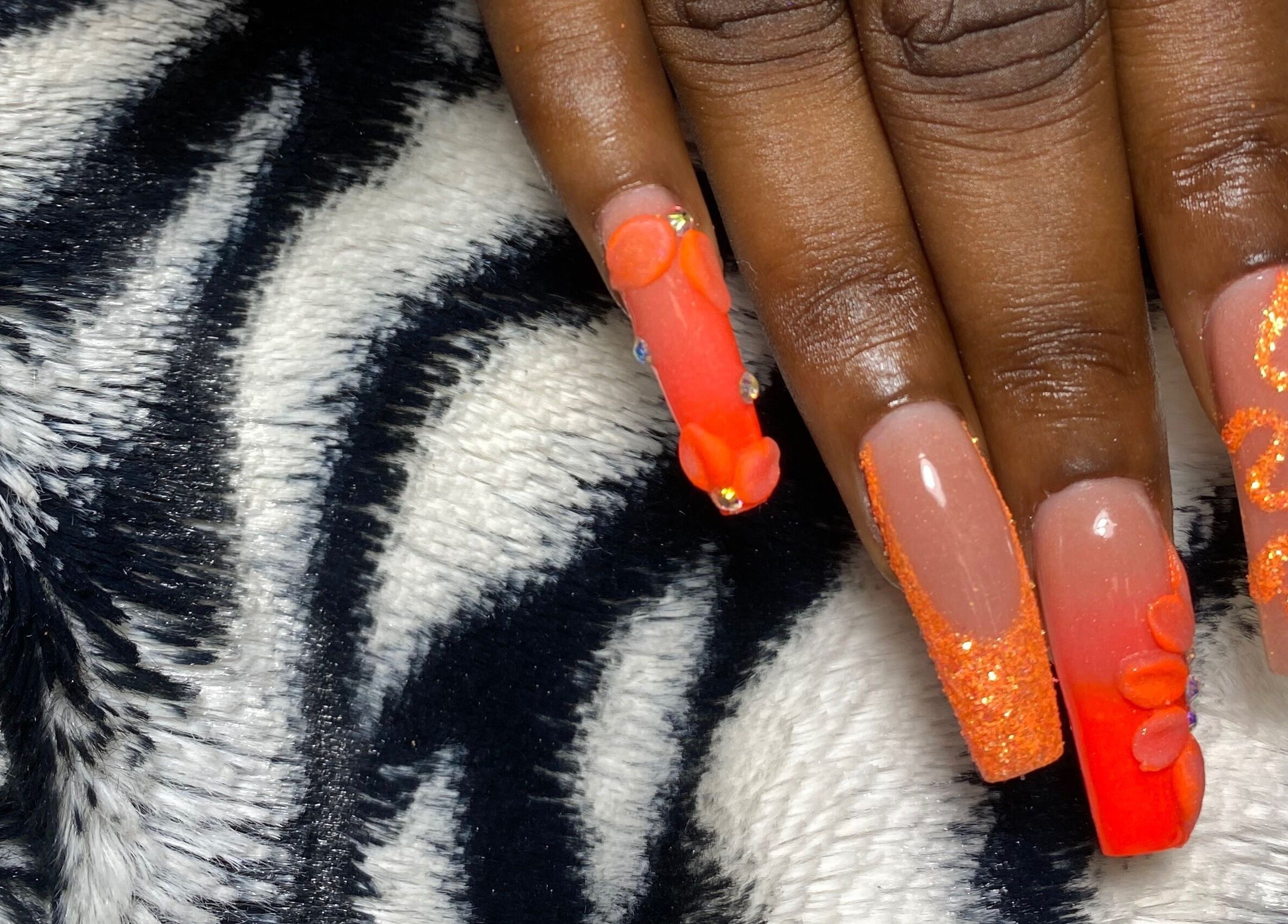 Vibrant orange nail art design at Tiff’s Creations, Bridgetown, Saint Michael, BB, showcasing creative styles.