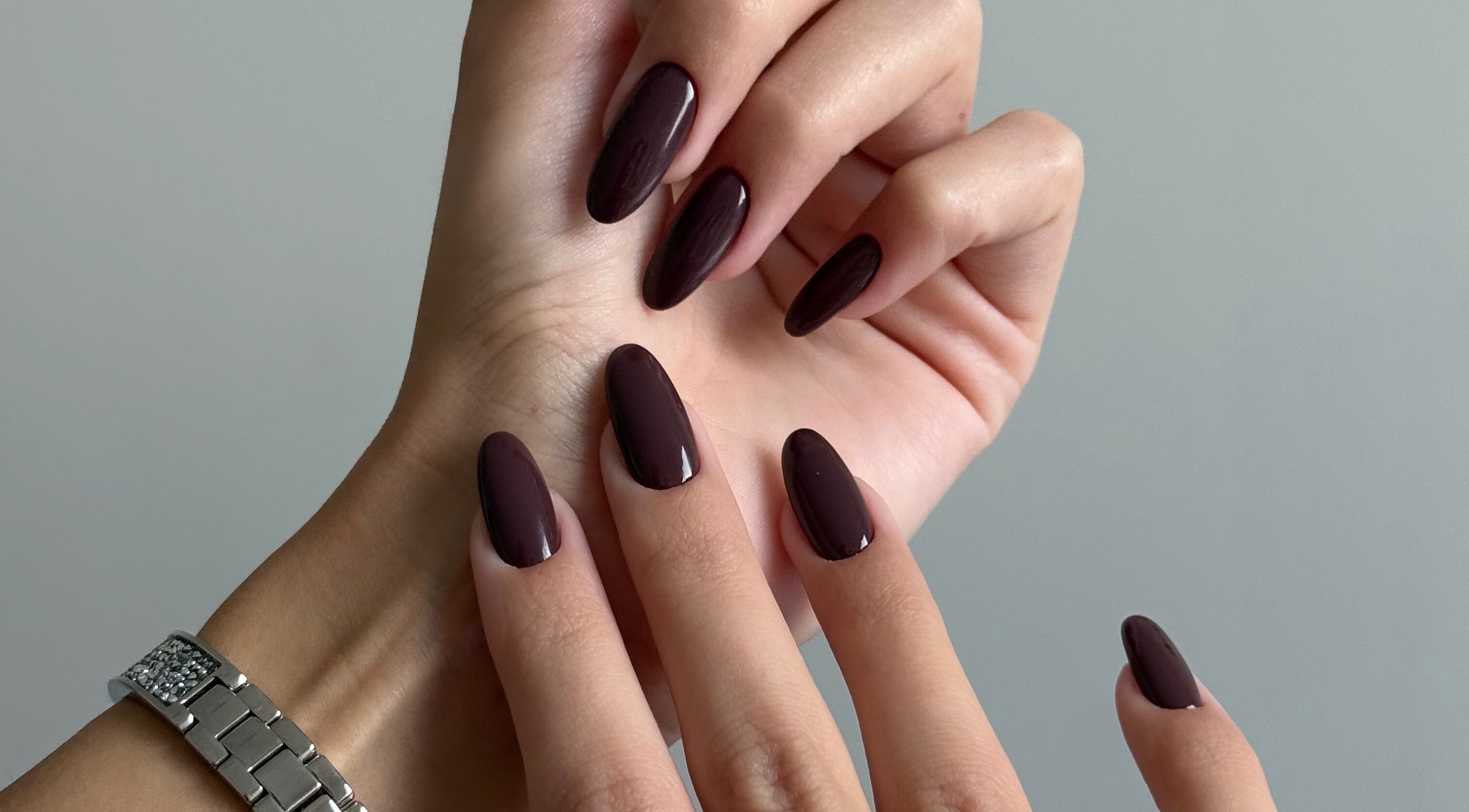 Elegant, dark burgundy nails from Luxuria Nails Co in Portsmouth, England, GB showcasing expert manicure.