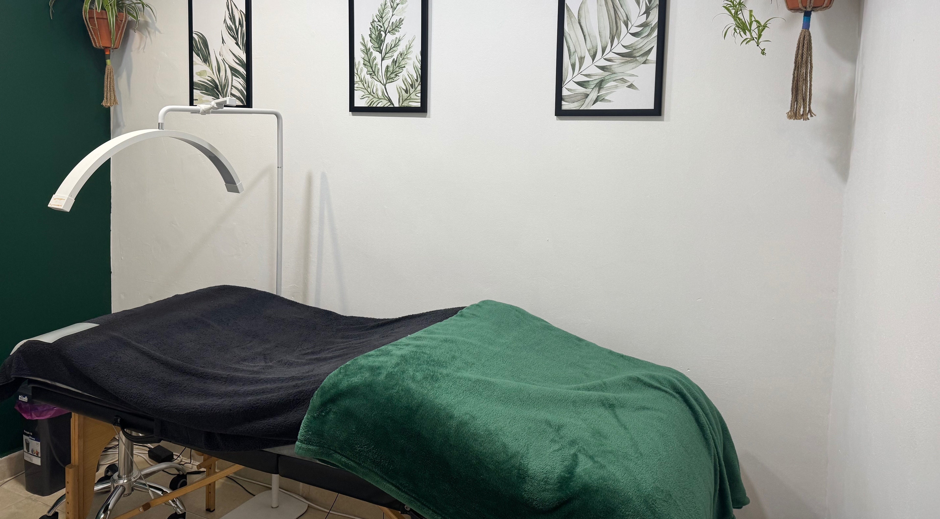 Tranquil treatment room at Studio 48, Randburg, Gauteng, ZA showing a massage bed with green accents.