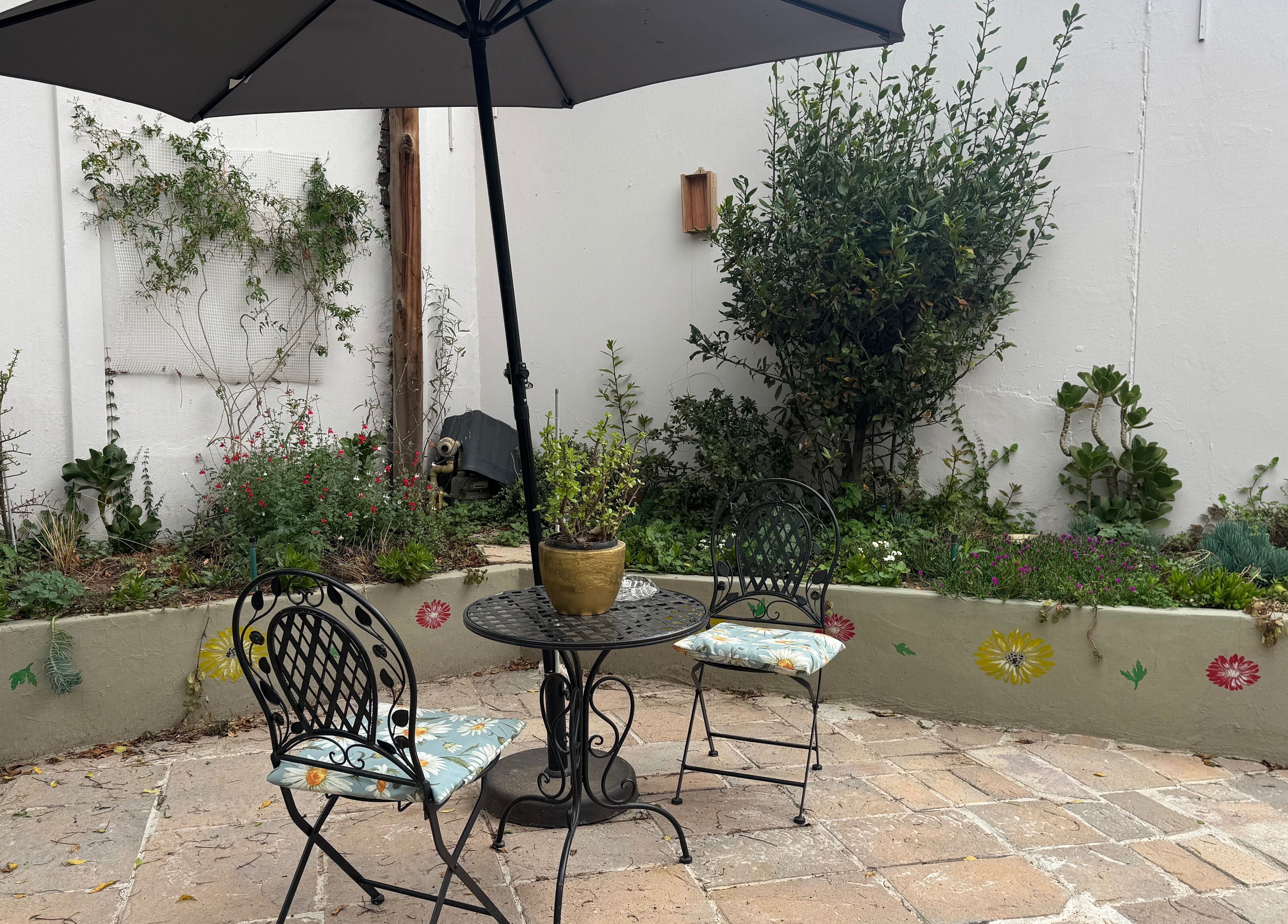 Charming garden patio at Studio 48 in Randburg, Gauteng, ZA with seating and lush greenery.