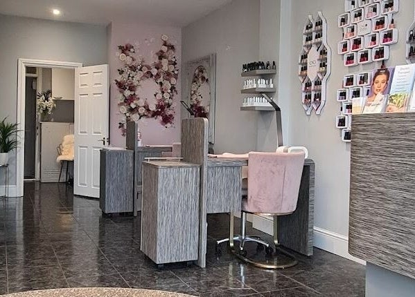 Chic interior of Allure Boutique in High Wycombe, England featuring nail stations and floral decor.