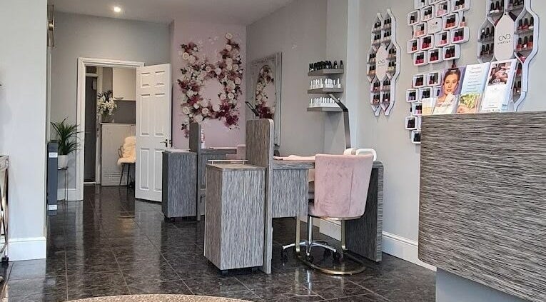Chic interior of Allure Boutique in High Wycombe, England featuring nail stations and floral decor.