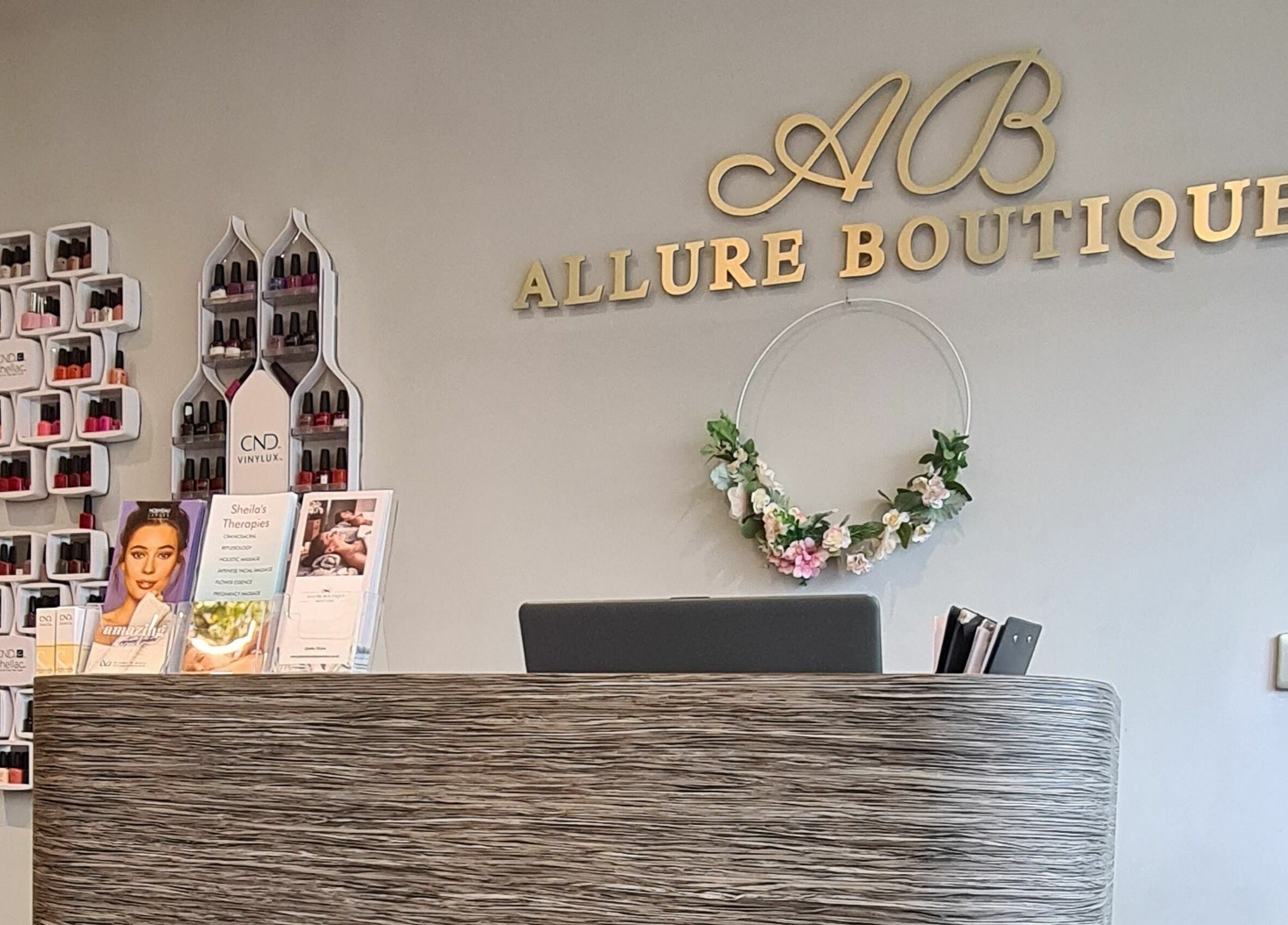 Elegant reception desk at Allure Boutique, High Wycombe, England, GB, with stylish decor and nail polish displays.