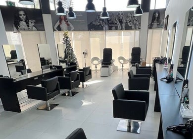 Modern salon interior at Rami Makeover Hair and Beauty Salon in DIFC, Dubai, AE, featuring sleek styling stations.