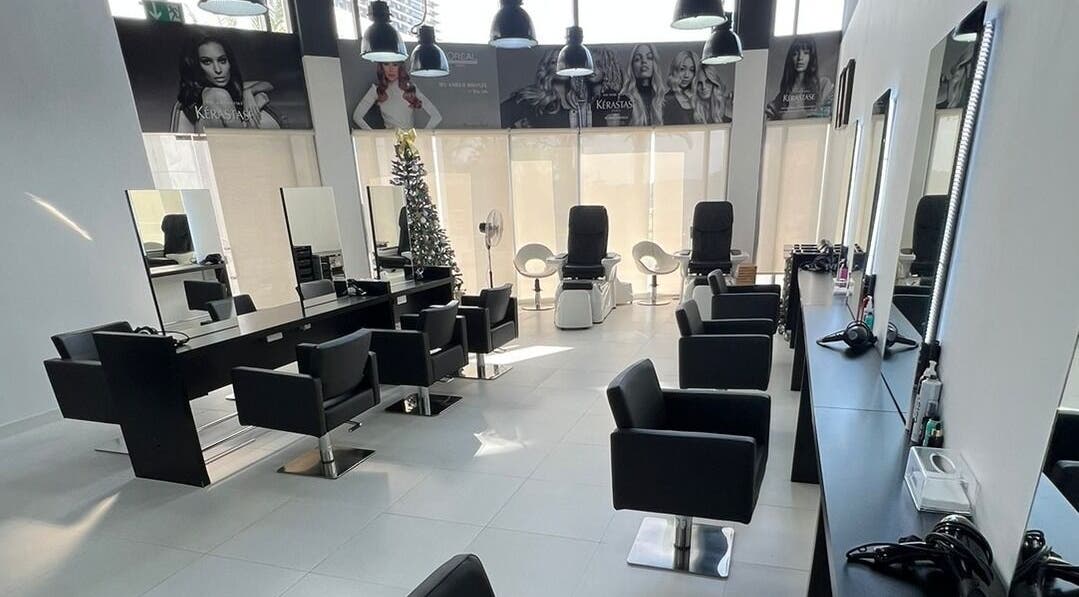 Modern salon interior at Rami Makeover Hair and Beauty Salon in DIFC, Dubai, AE, featuring sleek styling stations.