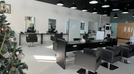 Modern interior of Rami Makeover Hair and Beauty Salon in DIFC, Dubai, AE, with stylish chairs and mirrors.