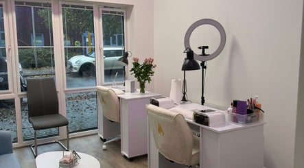 Interior of Nail Paradise by Neferka in Ashford, England with bright windows and nail stations.