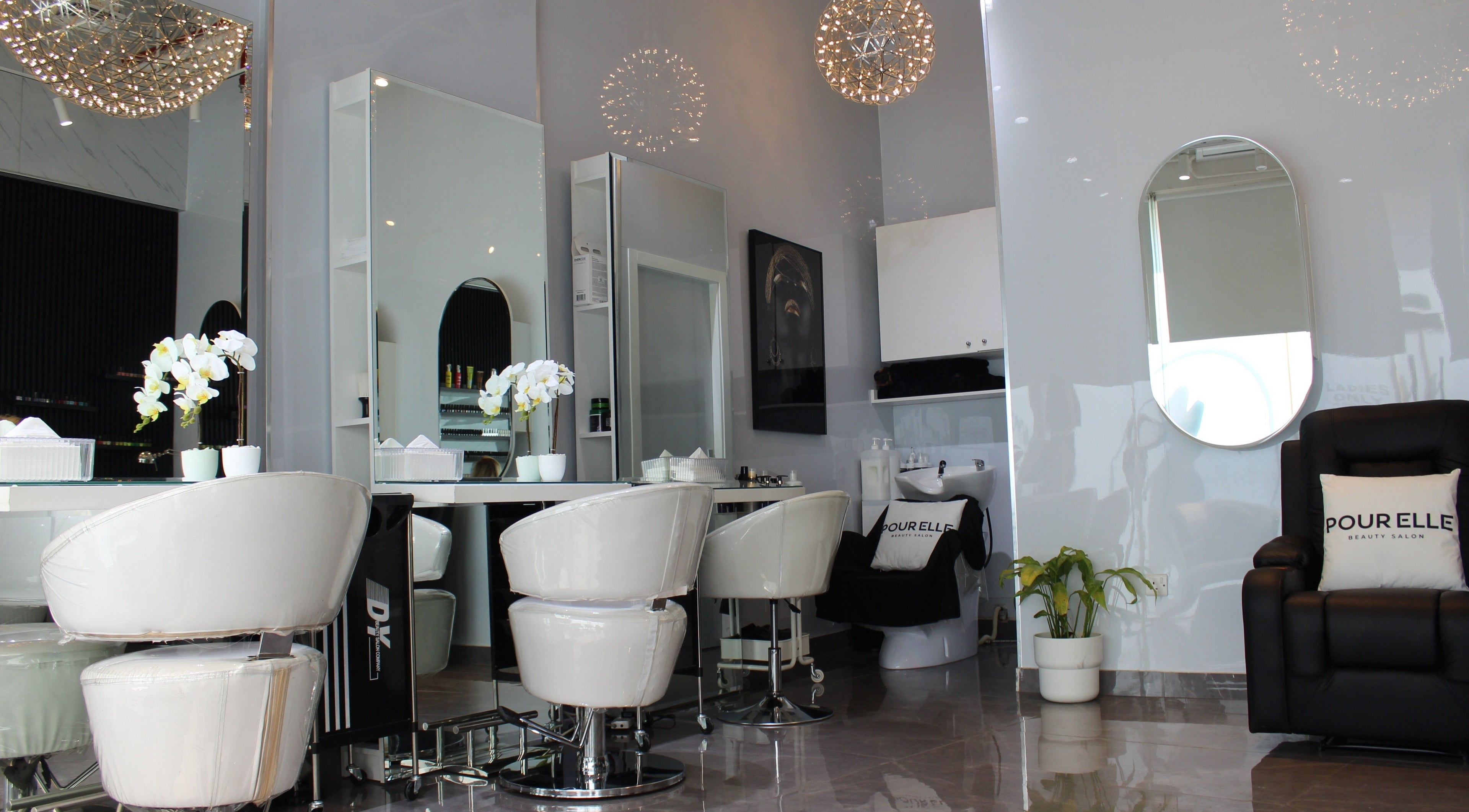 Elegant interior of Pour Elle Beauty Studio in Dubai featuring modern chairs and stylish decor.
