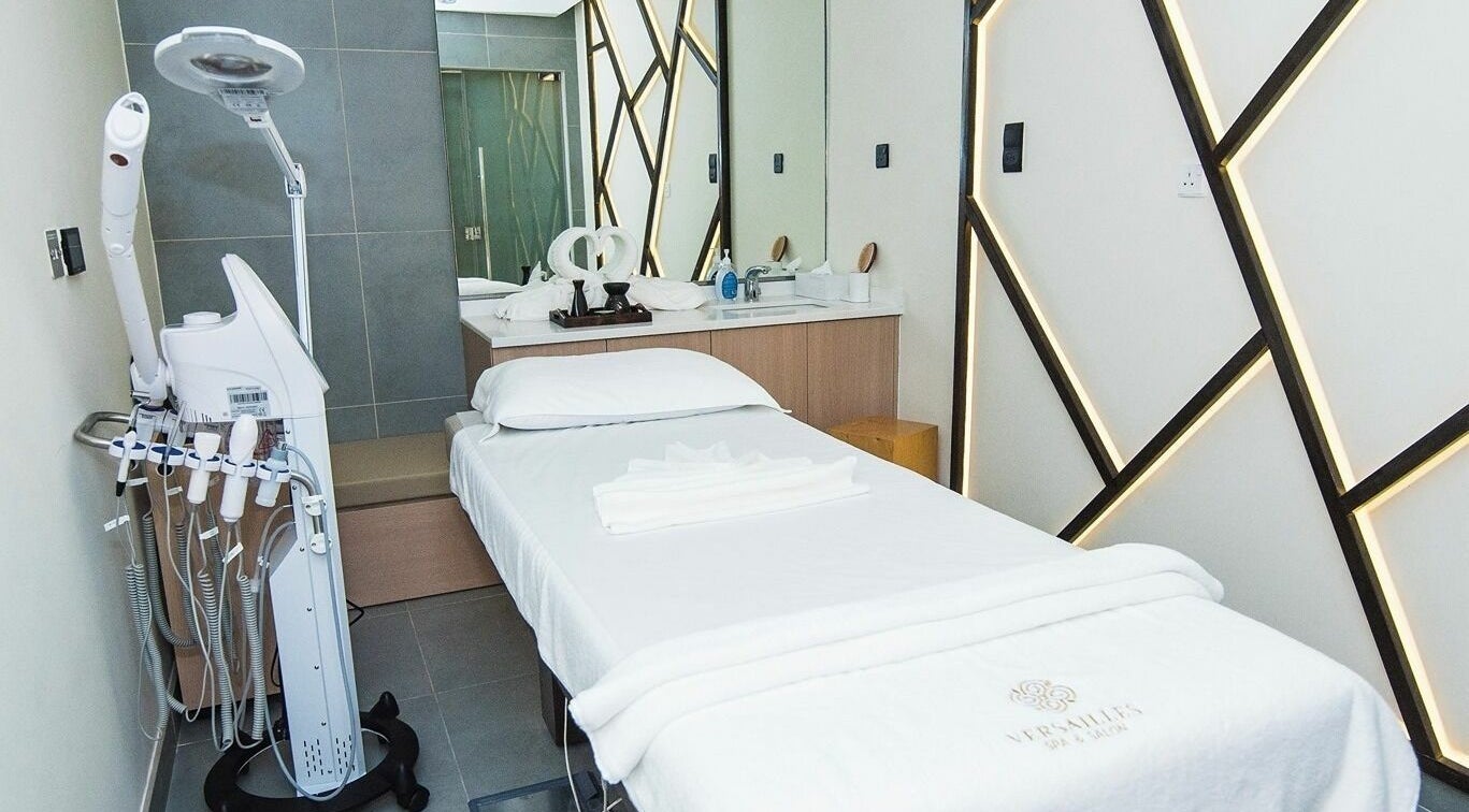 Relaxing spa room at Versailles Spa and Salon - Aloft Hotel, Dubai, AE, featuring a treatment bed and modern decor.