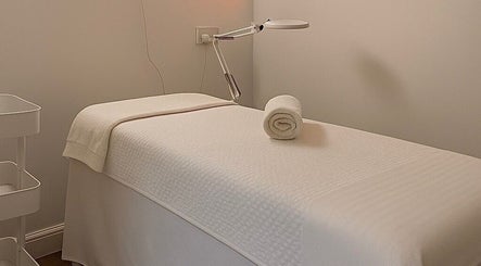 Tranquil treatment room at Perfect Look By Aman in Hitchin, England, GB, featuring a cozy massage table.