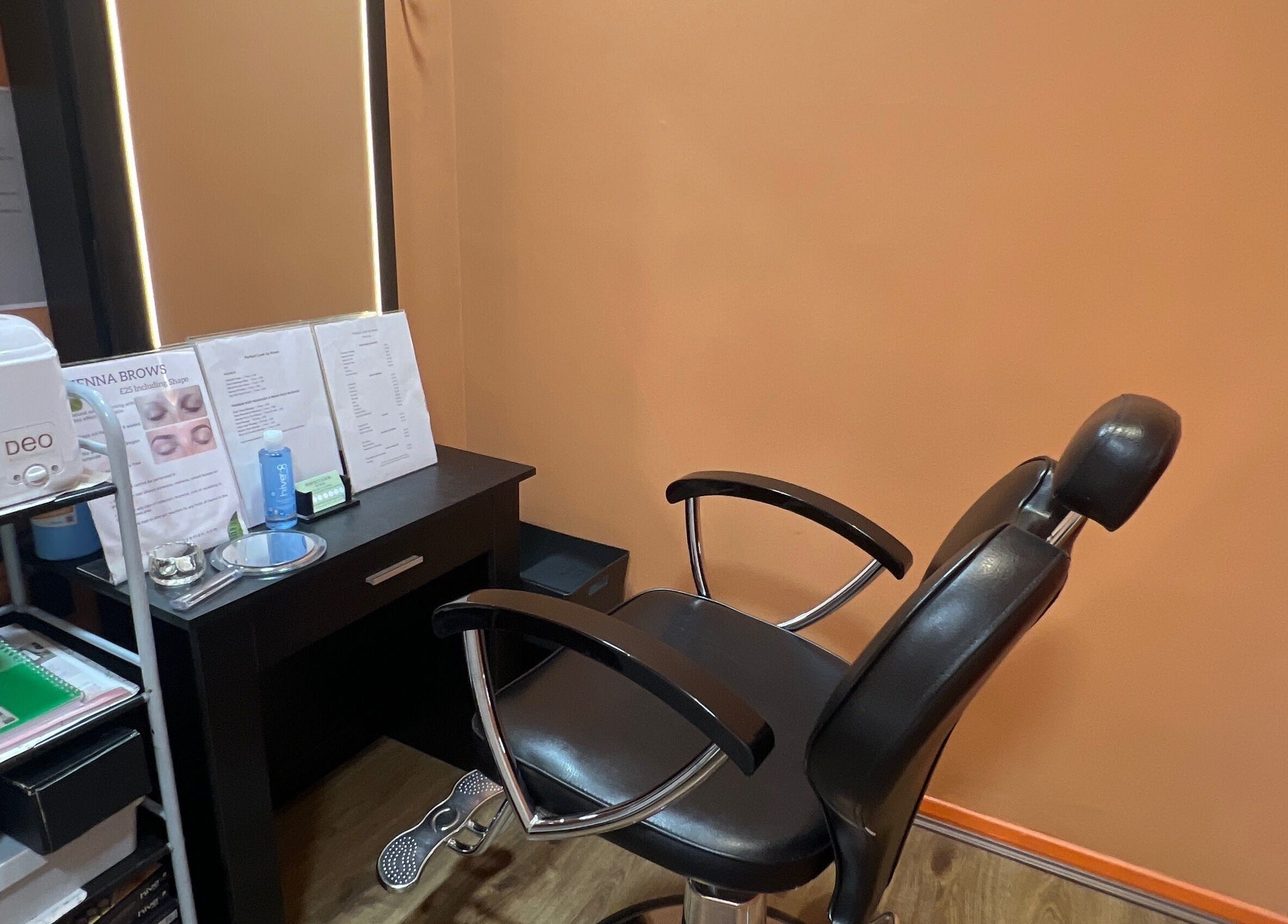 Cozy treatment area at Perfect Look By Aman in Hitchin, England, GB featuring a modern salon chair.