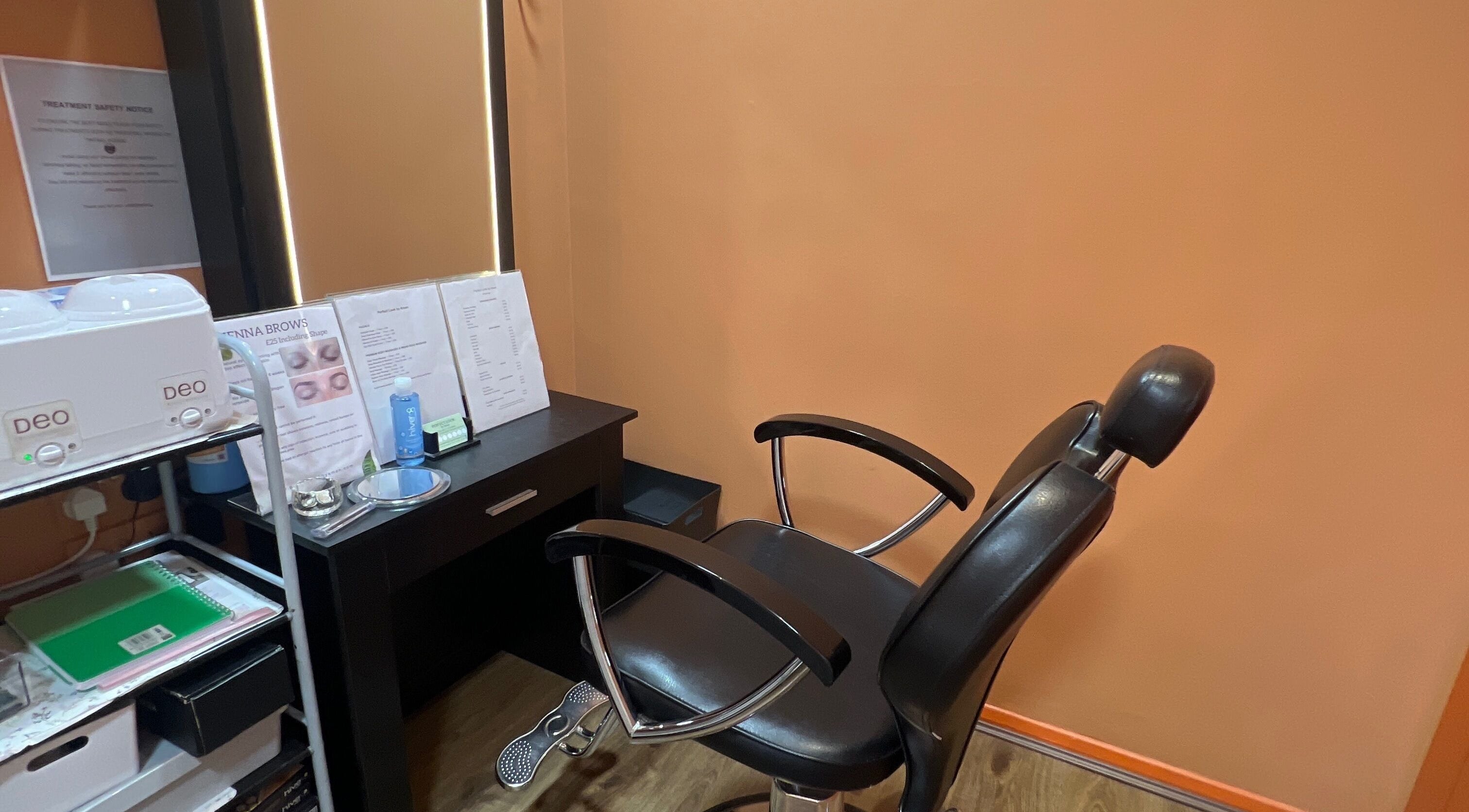 Cozy treatment area at Perfect Look By Aman in Hitchin, England, GB featuring a modern salon chair.