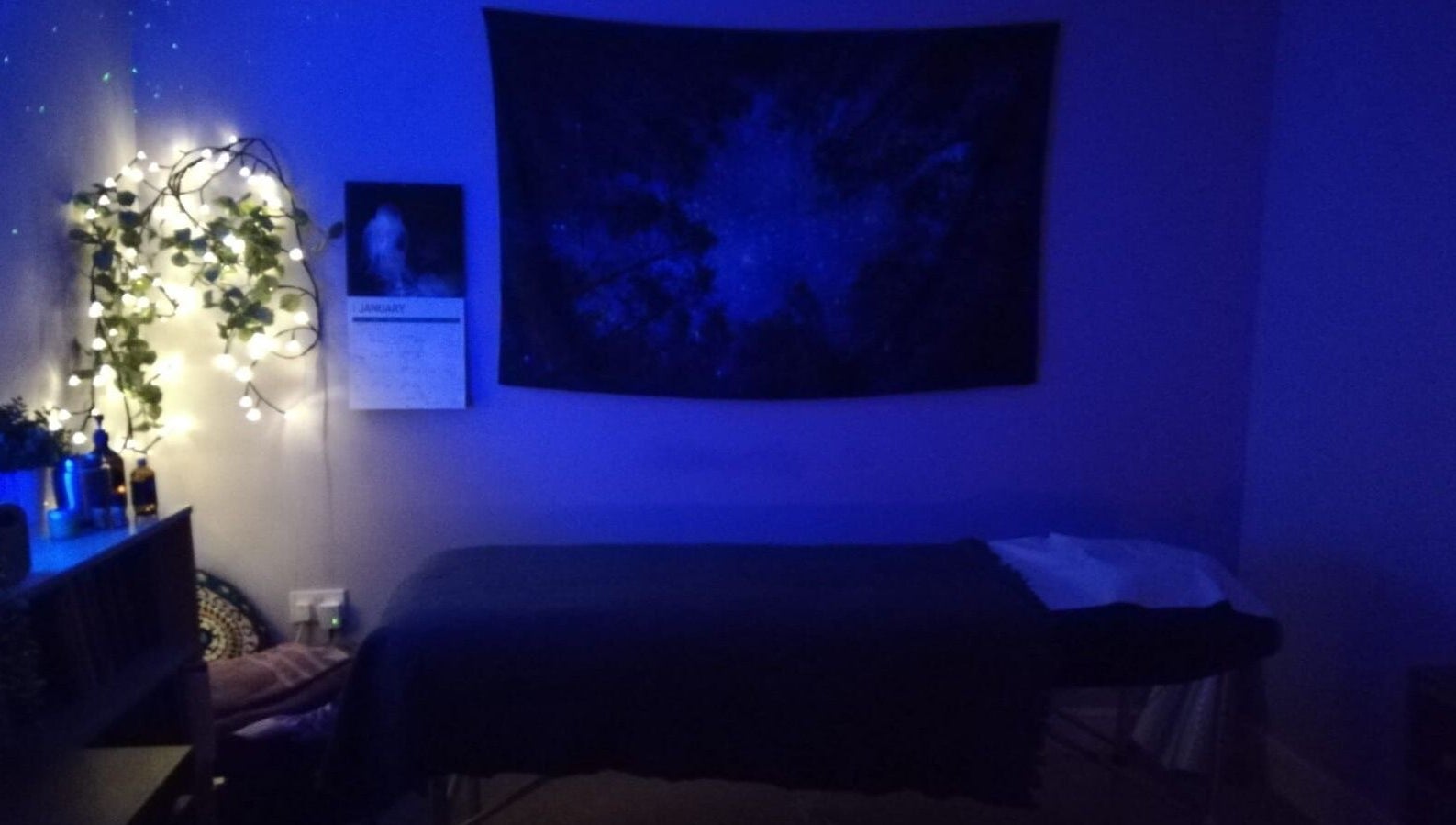 Relaxing treatment room at Violet Moon, Westcroft, England, GB, adorned with soft lighting and calming decor.