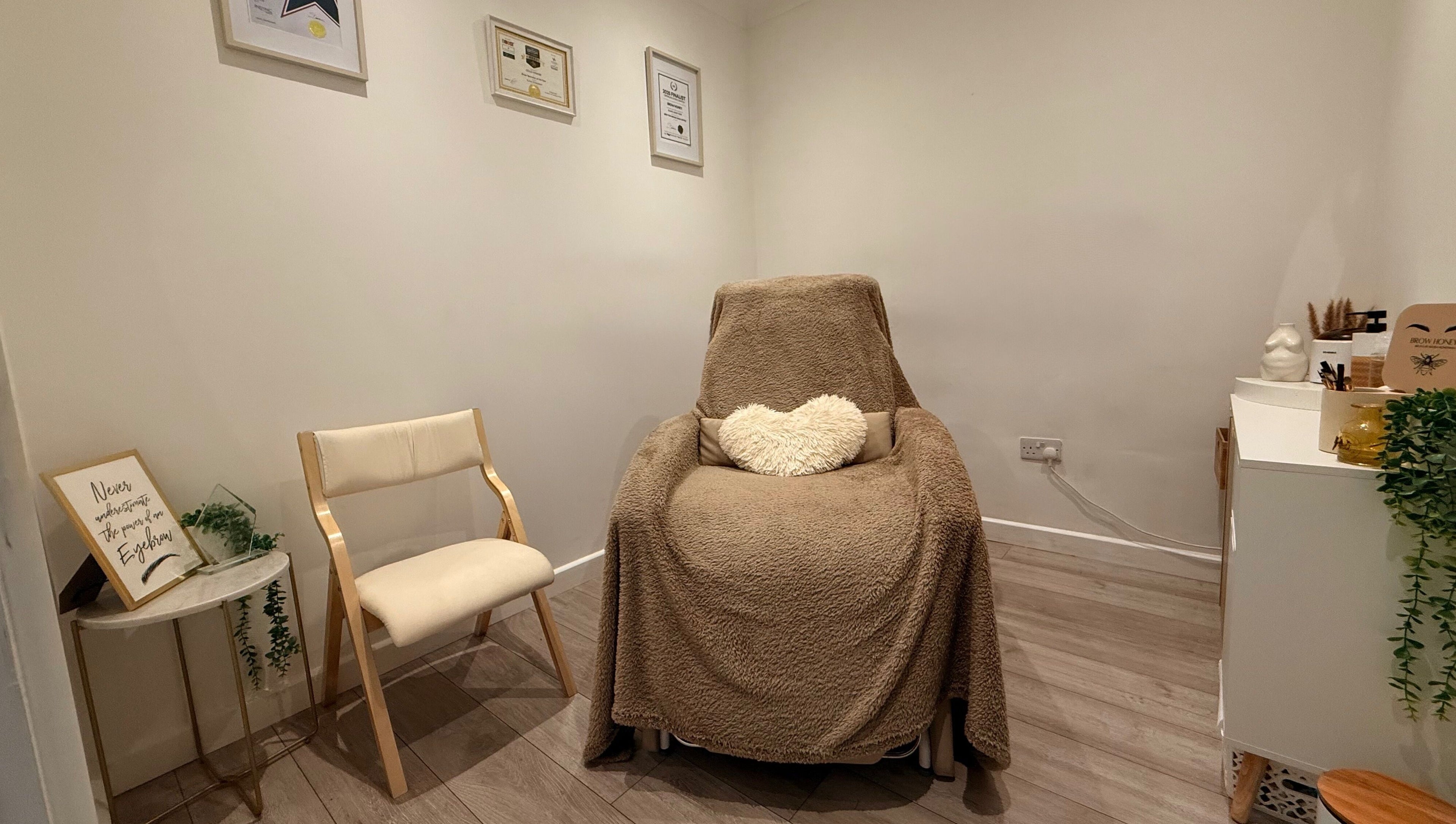Relaxing treatment room at Brow Honey, Darlington, England, GB with comfy chair and serene ambiance.