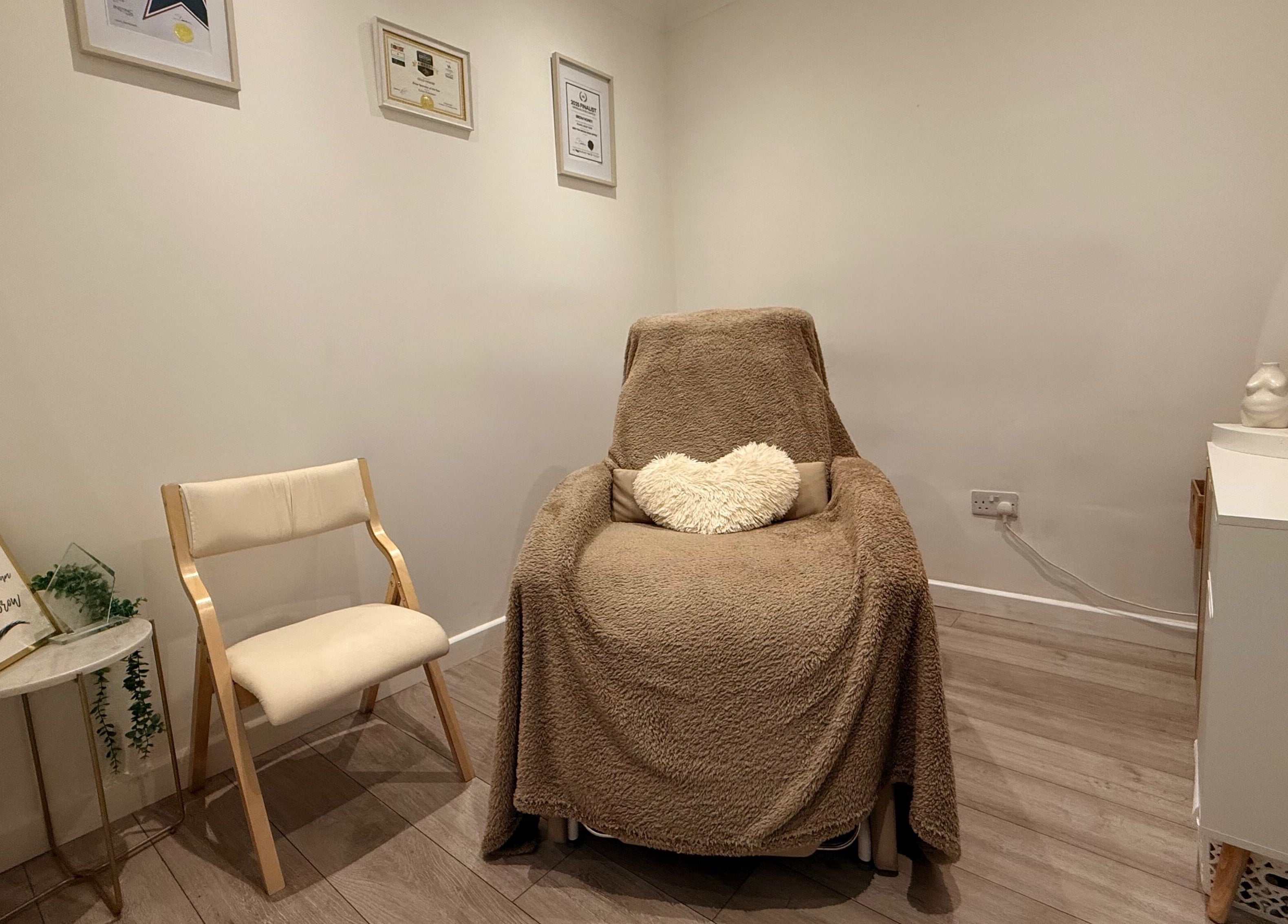 Relaxing treatment room at Brow Honey, Darlington, England, GB with comfy chair and serene ambiance.