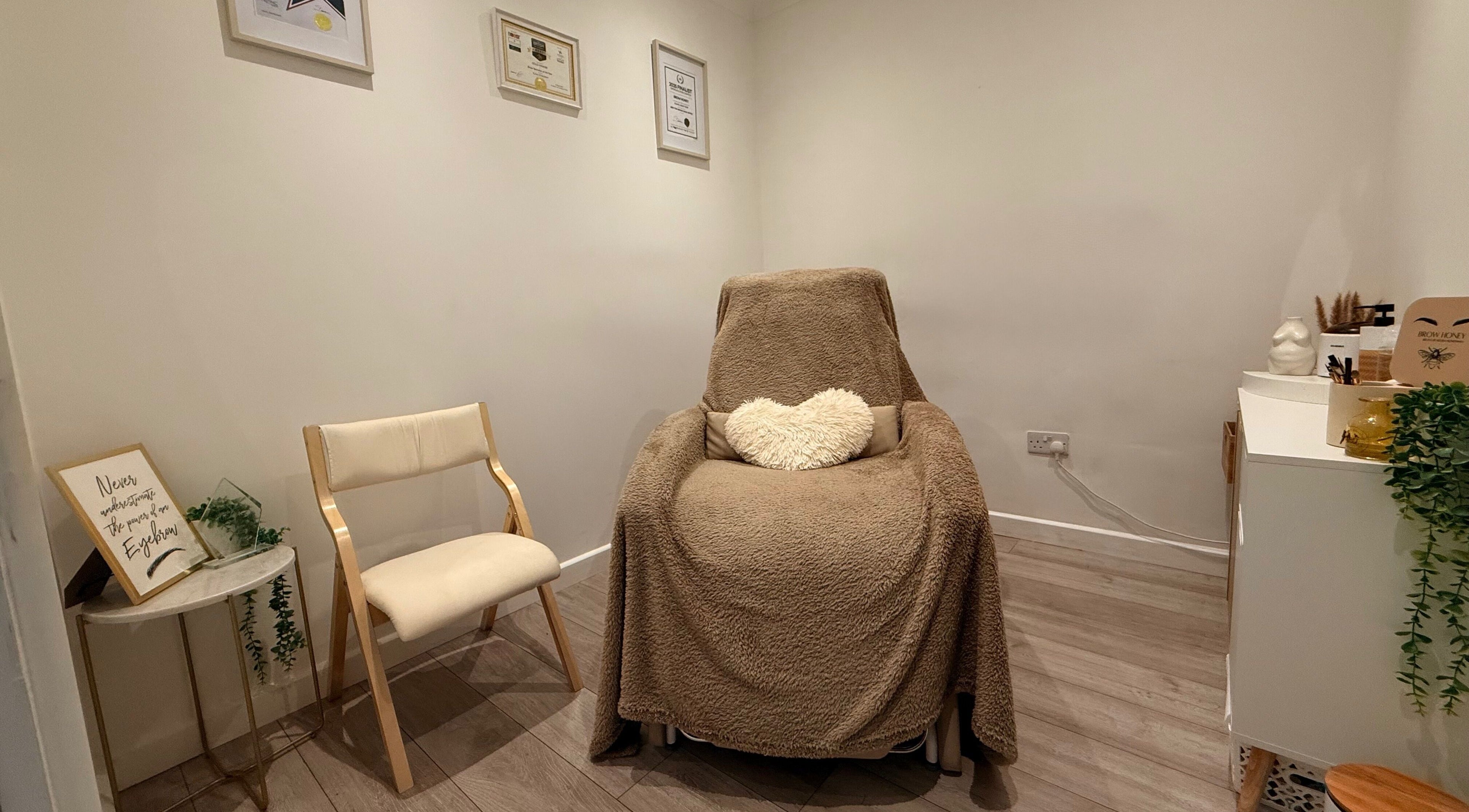 Relaxing treatment room at Brow Honey, Darlington, England, GB with comfy chair and serene ambiance.