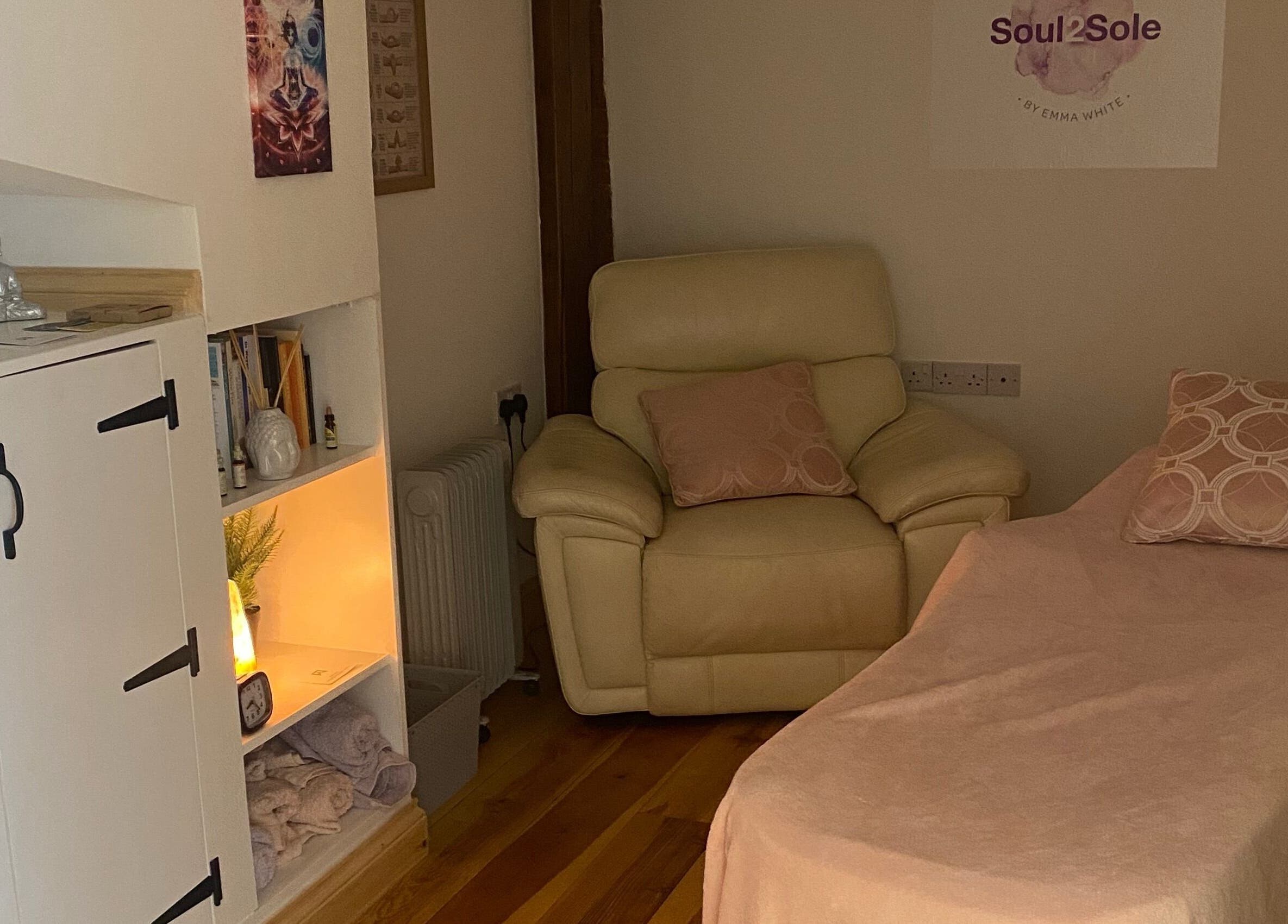 Relaxing treatment room at Soul2Sole by Emma White in Egmanton, England, GB featuring a plush chair and ambient lighting.