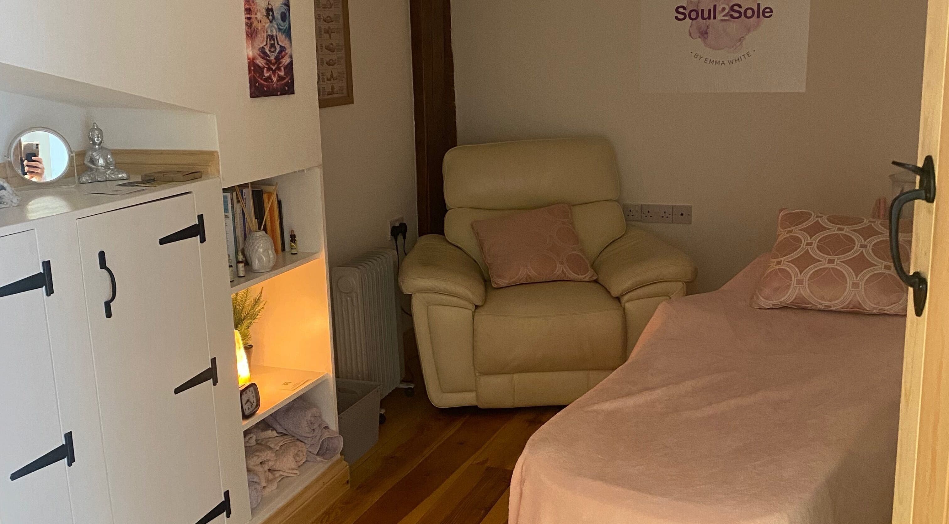 Relaxing treatment room at Soul2Sole by Emma White in Egmanton, England, GB featuring a plush chair and ambient lighting.