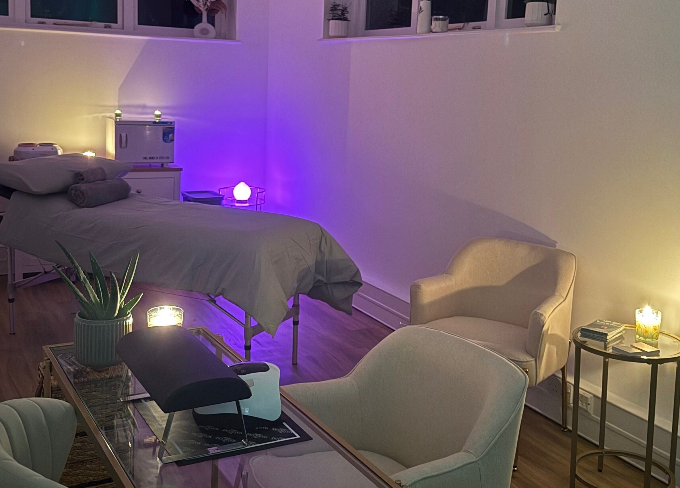 Relaxing treatment room at Beauty by Elliemai, Rowlands Castle, England, GB with ambient lighting and cozy seating.