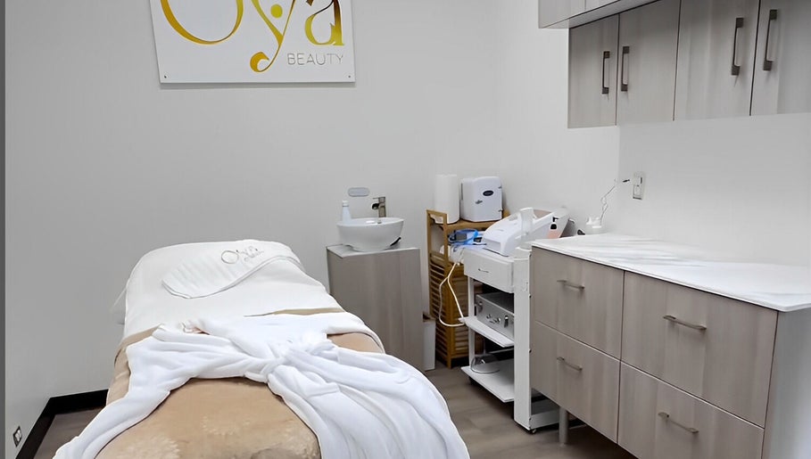 OYA Wellness - Brickell, Miami, Florida, US treatment room with cozy massage table and spa essentials.