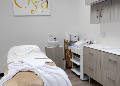 OYA Wellness - Brickell, Miami, Florida, US treatment room with cozy massage table and spa essentials.