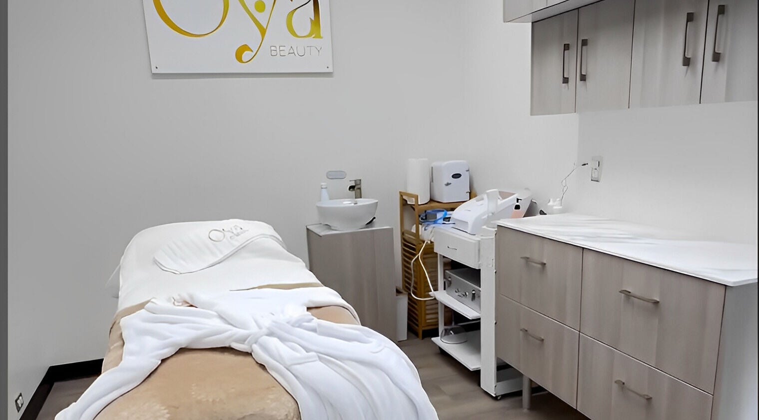 OYA Wellness - Brickell, Miami, Florida, US treatment room with cozy massage table and spa essentials.