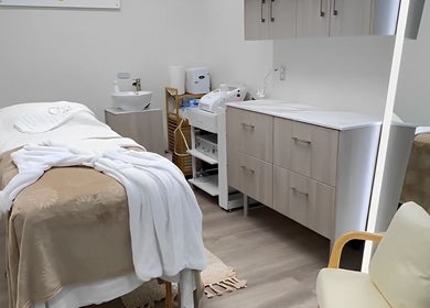 Tranquil treatment room at OYA Wellness - Brickell, Miami, Florida, US with cozy massage table and elegant decor.