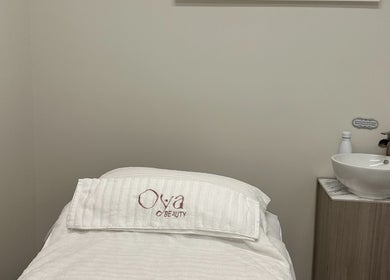 Tranquil treatment room at OYA Wellness - Brickell, Miami, Florida, US, featuring a cozy treatment bed and modern sink.