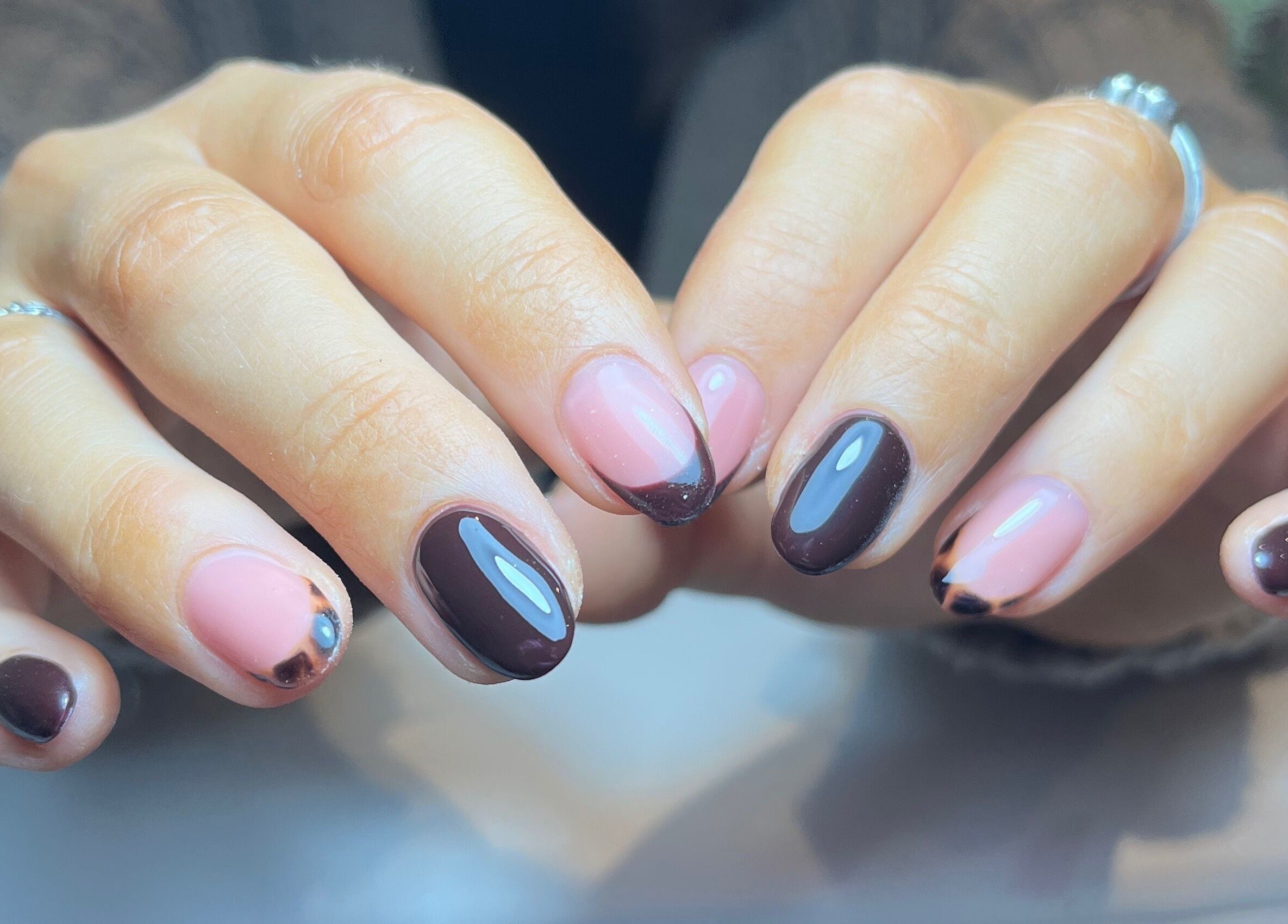 Chic nail art at Green with Envy Nails, Sutton, South London, England, GB showcasing brown and pink designs.