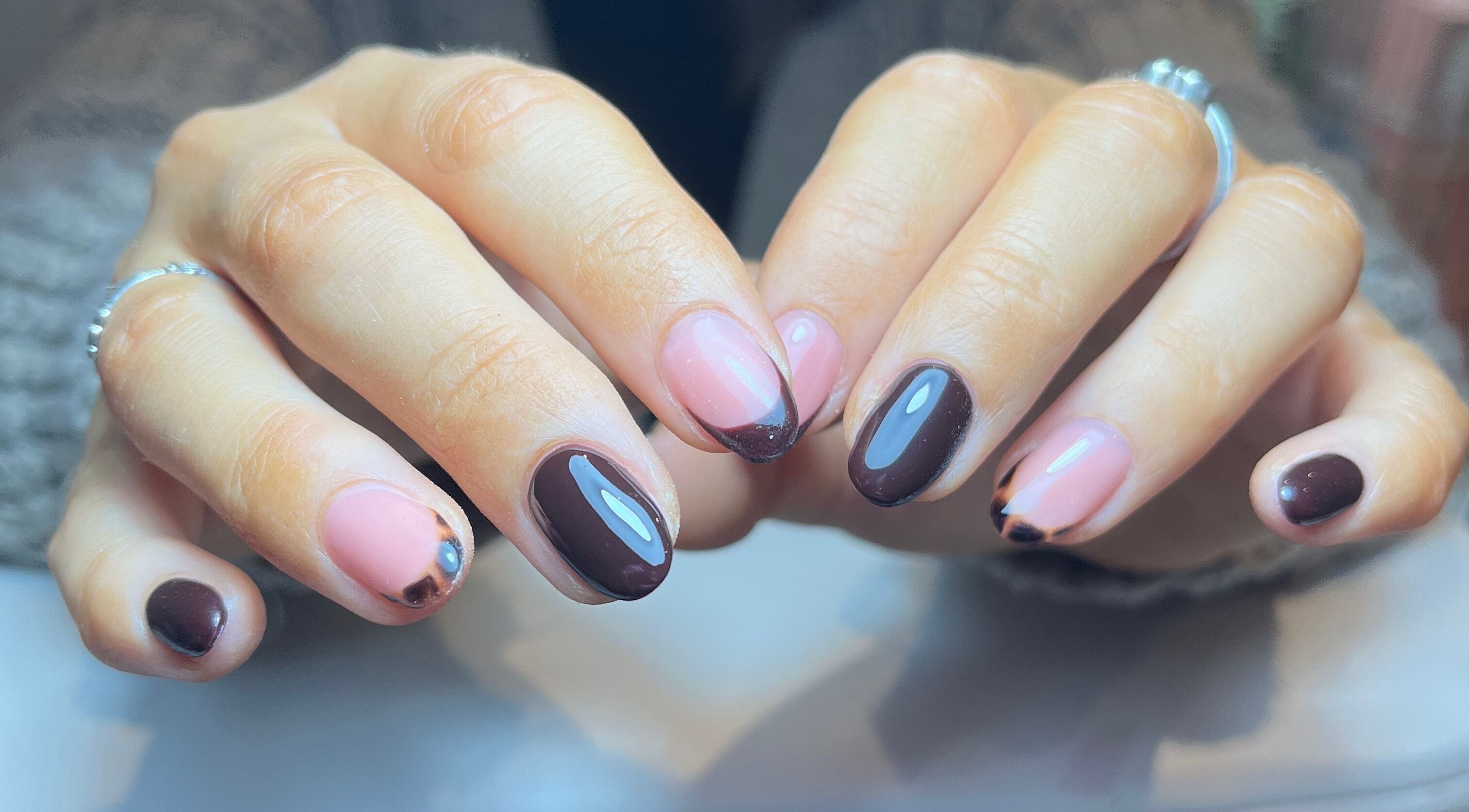 Chic nail art at Green with Envy Nails, Sutton, South London, England, GB showcasing brown and pink designs.