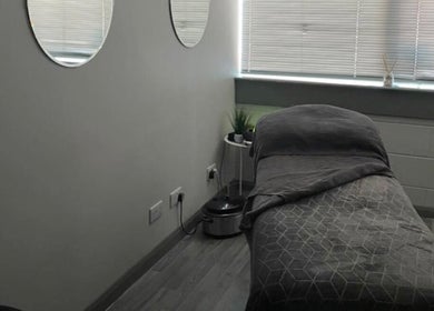 Tranquil massage room at R and R Tranquility, Aberdeen, Scotland, GB. Cozy ambiance with soft lighting.