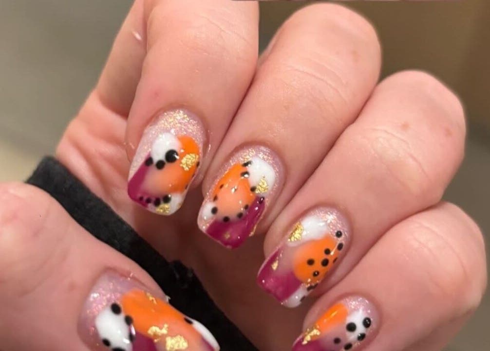 Vibrant nail art with orange and purple at R and R Tranquility, Aberdeen, Scotland, GB.