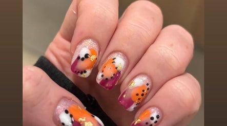 Vibrant nail art with orange and purple at R and R Tranquility, Aberdeen, Scotland, GB.