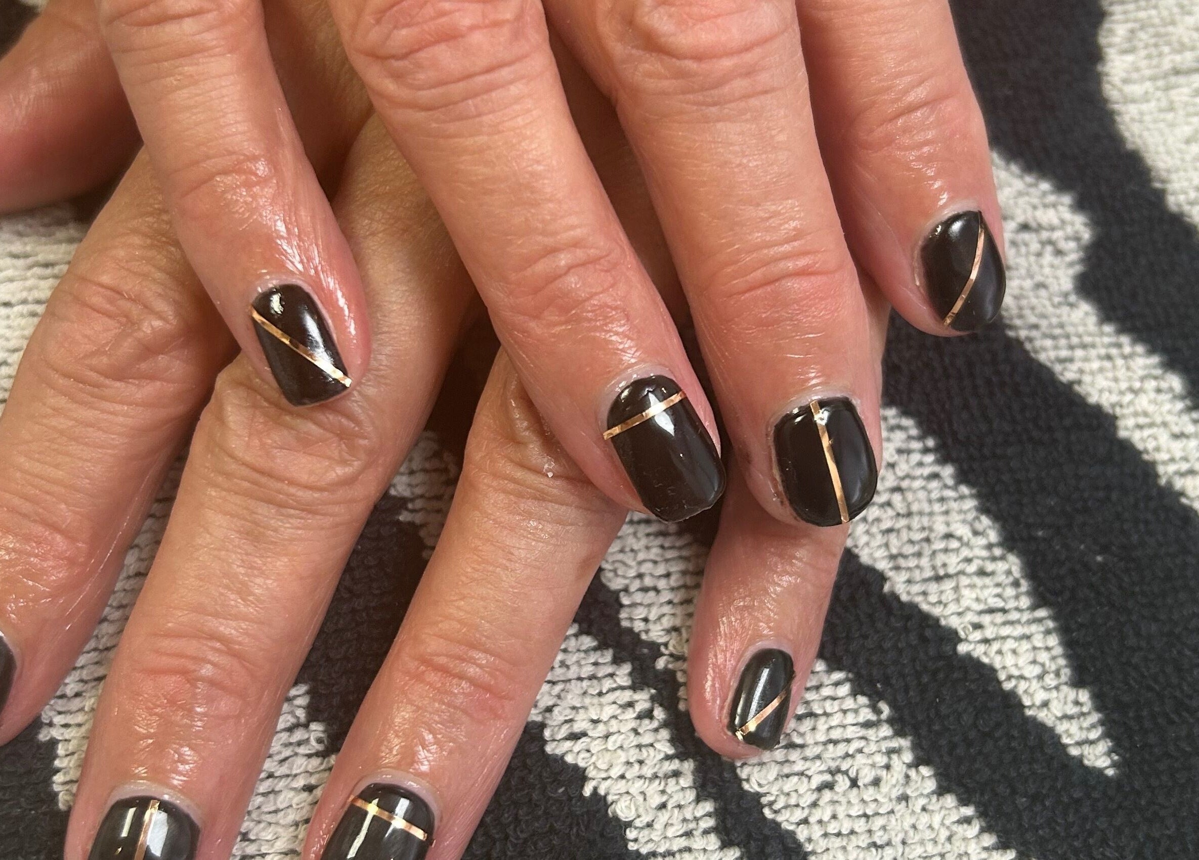 Stylish black and gold nail art at R and R Tranquility, Aberdeen, Scotland, GB.