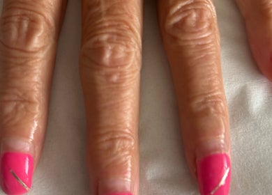 Bright pink manicured nails at R and R Tranquility in Aberdeen, Scotland, GB.