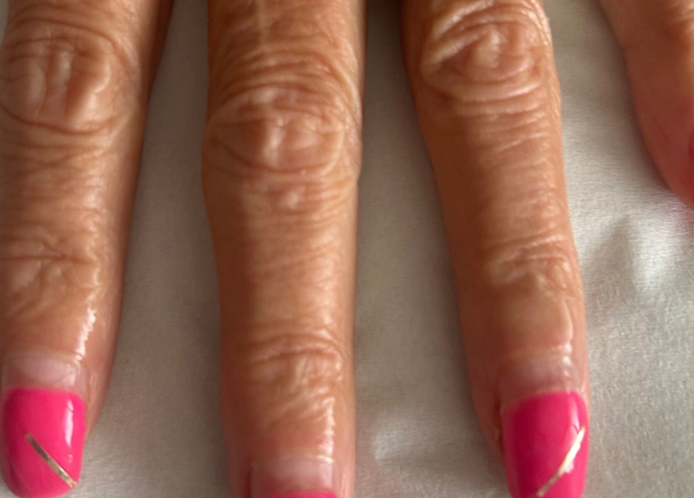 Bright pink manicured nails at R and R Tranquility in Aberdeen, Scotland, GB.