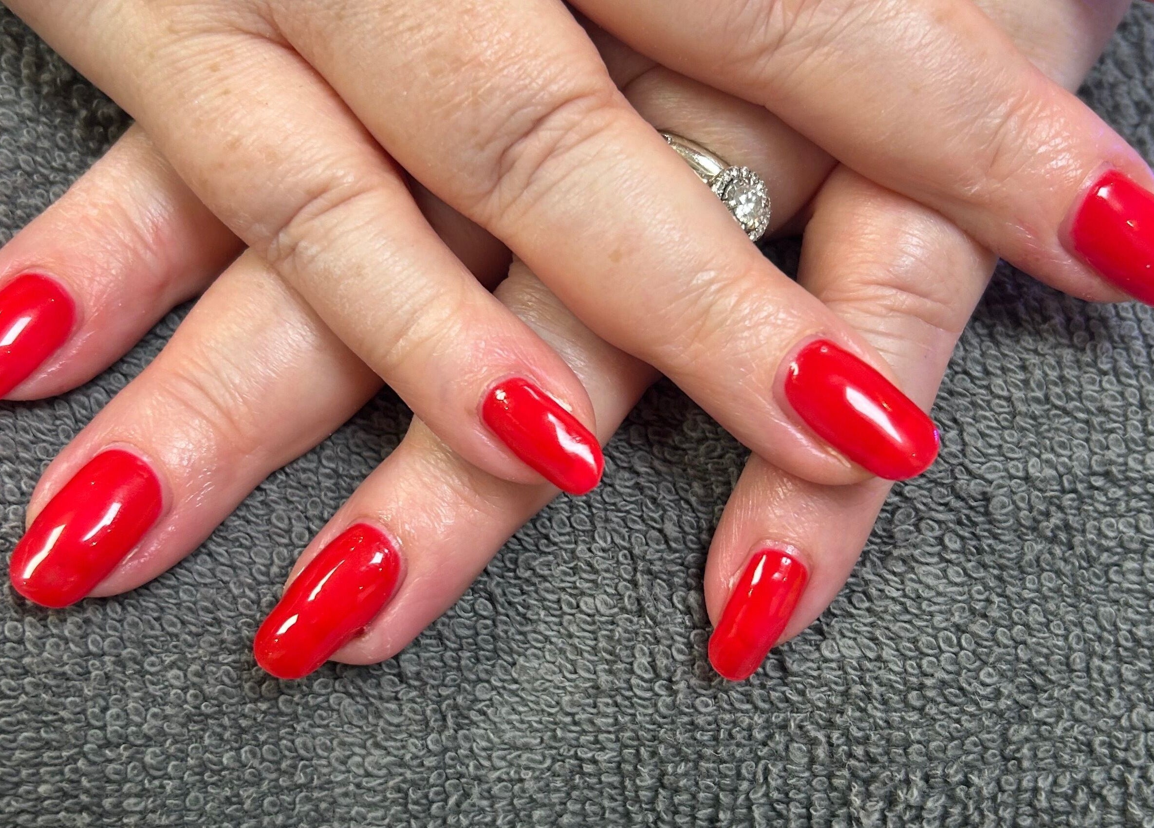 Freshly manicured red nails at R and R Tranquility in Aberdeen, Scotland, GB.