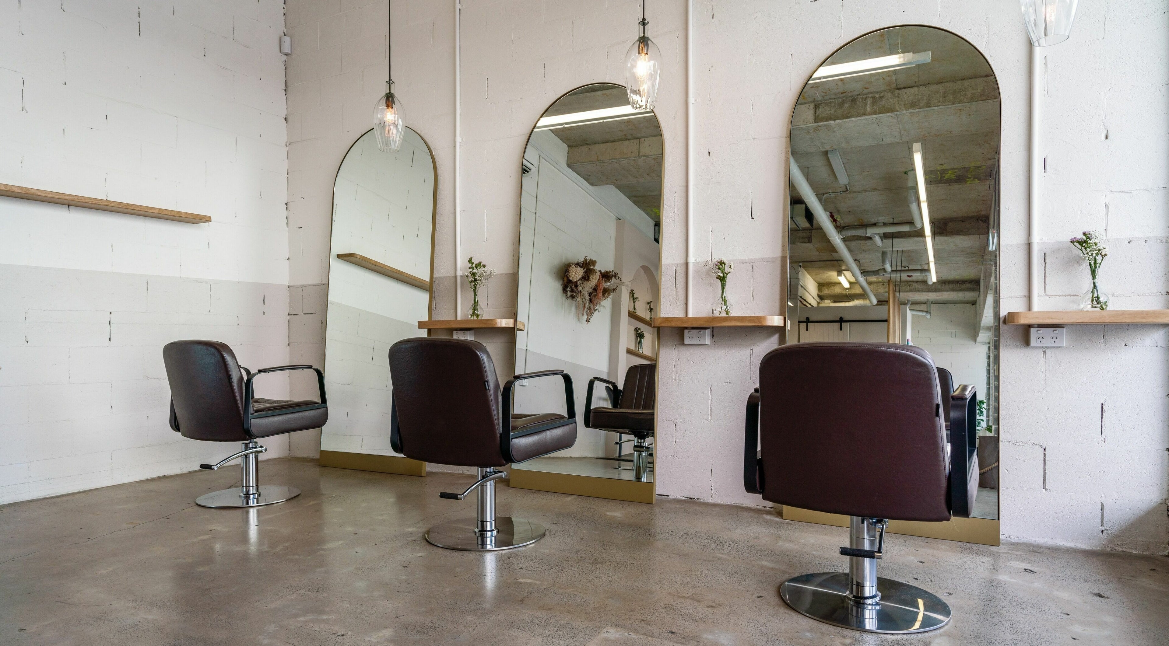Modern salon interior at Galen Colour, Alexandria, New South Wales, AU with stylish mirrors and chairs.
